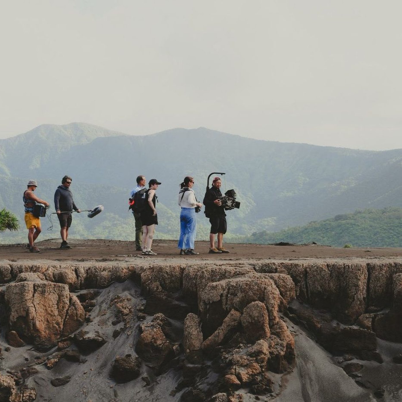 A film crew on a rocky ridge